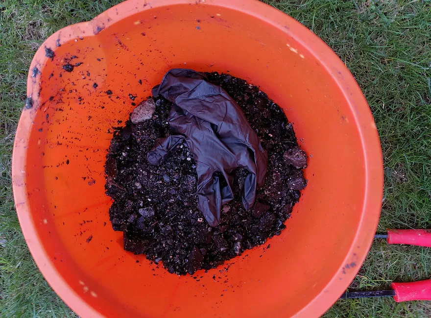 an orange bowl filled with dirt and dirt