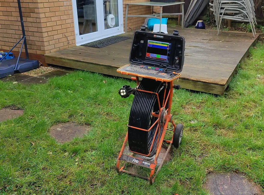 a small cart with a laptop on top of it